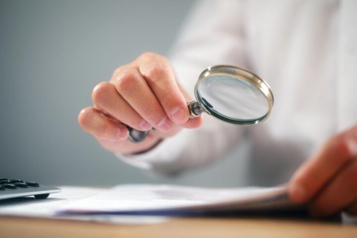 magnifying glass revieiwng a document